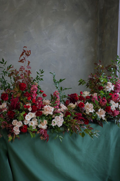  Luxurious red roses tribute casket spray with garden blooms in red, cream, dusty pinks, and deep greens by Ottawa florist.