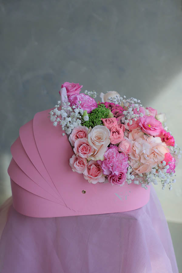 pink baby girl flowers; pink flower crib; flowers in a crib; baby girl flower arrangement; baby shower flowers 