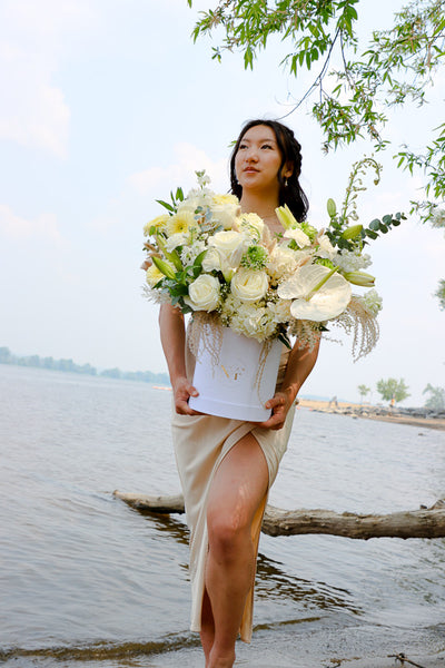 Luxurious floral arrangement with white roses, lilies, and hydrangeas in a tall white box by Ottawa florist.