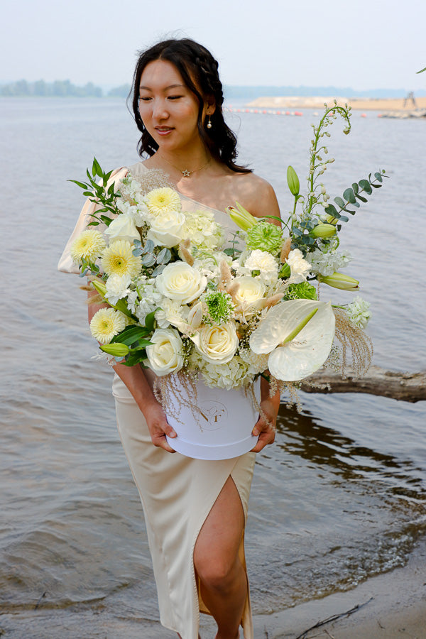 Luxurious floral arrangement with white roses, lilies, and hydrangeas in a tall white box by Ottawa florist.