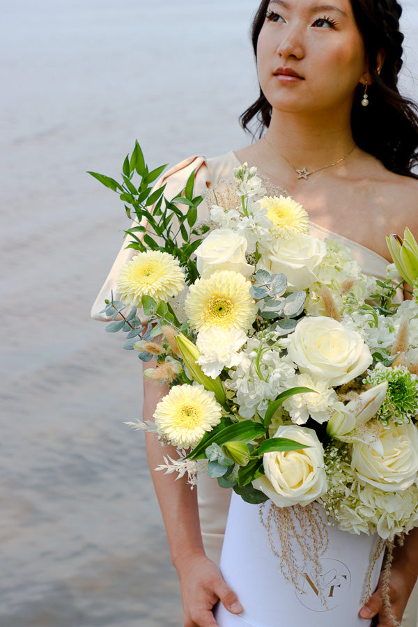 Luxurious floral arrangement with white roses, lilies, and hydrangeas in a tall white box by Ottawa florist.