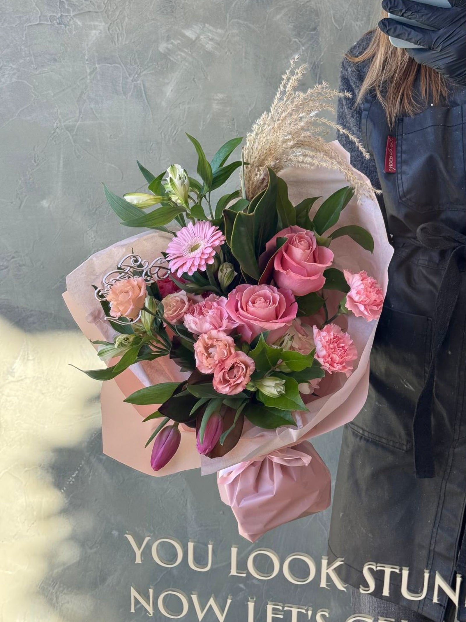 Bouquet of pink flowers with a person in a background