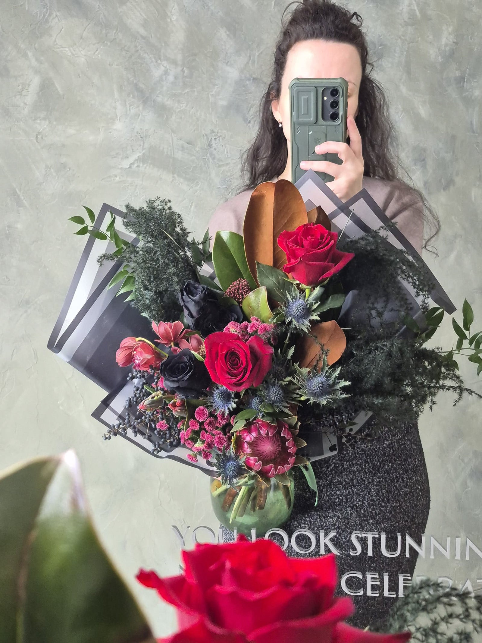 Dark and moody flower bouquet with black roses, red roses, protea - gothic flowers