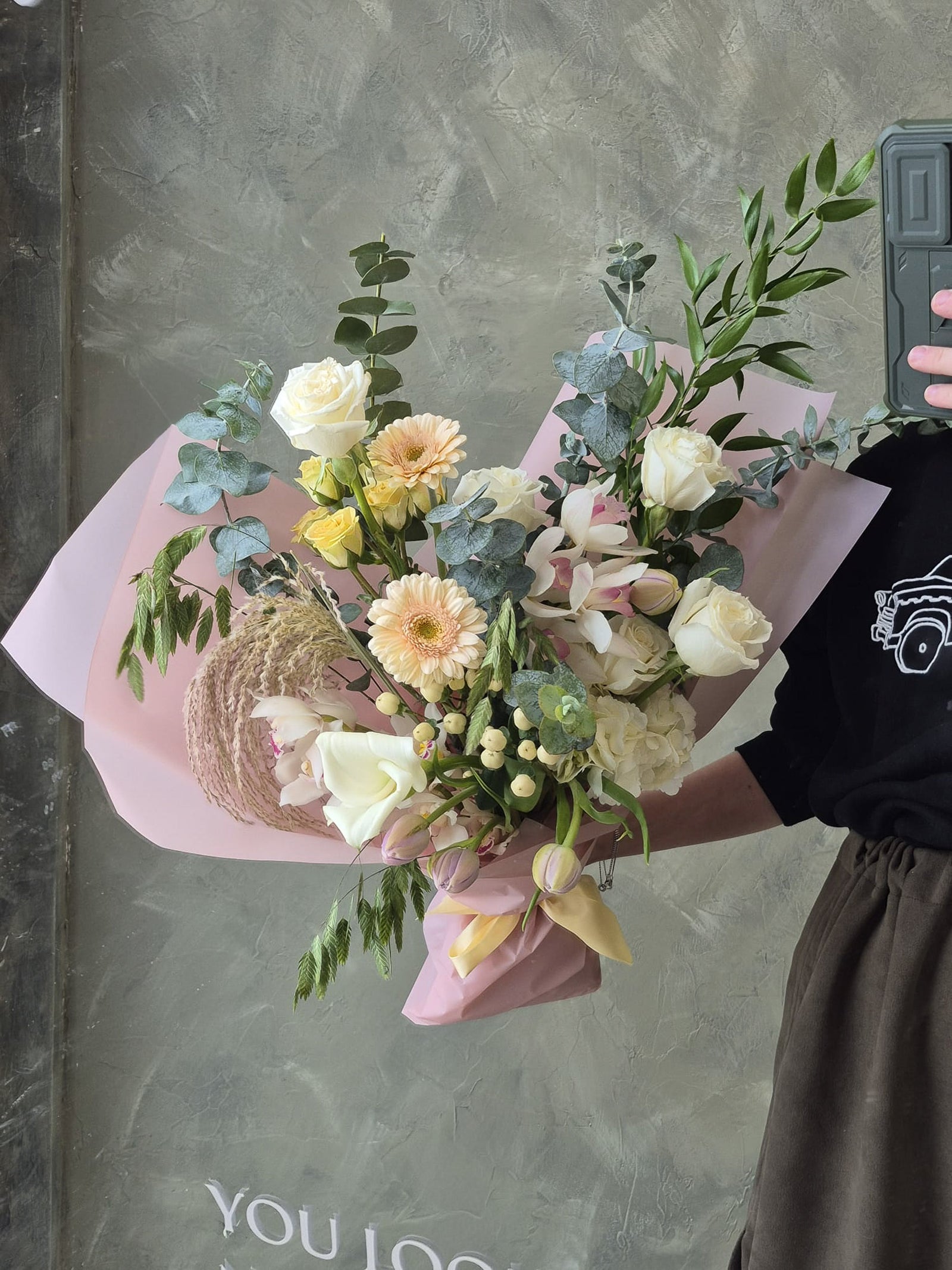 elegant neutral bouquet with white roses, peach gerberas, white orchids, eucalyptus and dry elements