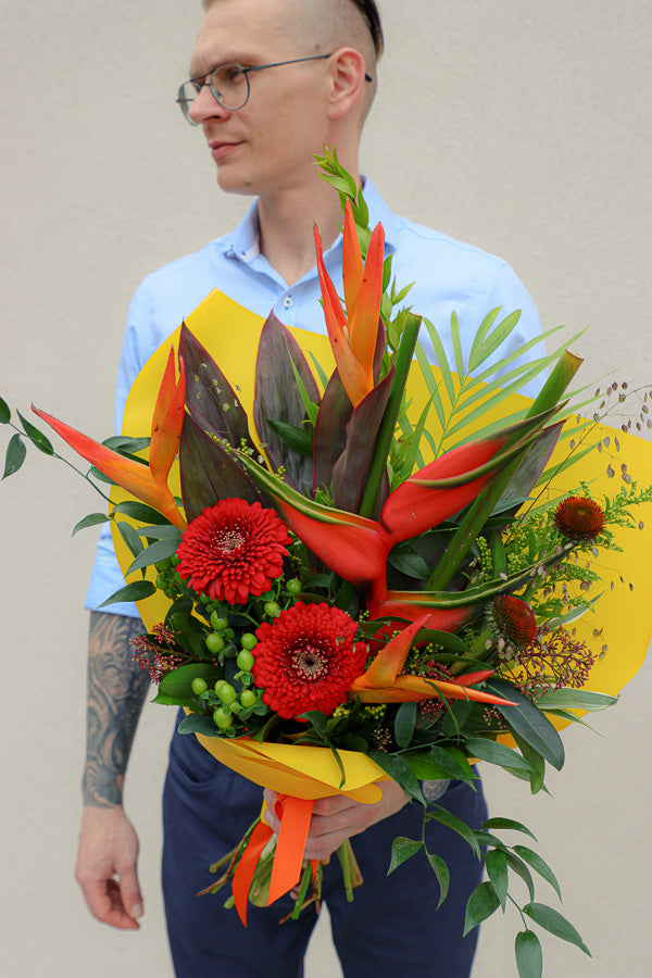 Vibrant Tropical Paradise bouquet with bright gerberas, heliconias, and lush tropical foliage by Ottawa florist.