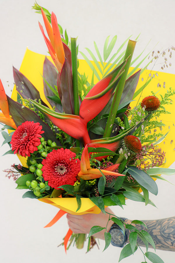 Vibrant Tropical Paradise bouquet with bright gerberas, heliconias, and lush tropical foliage by Ottawa florist.