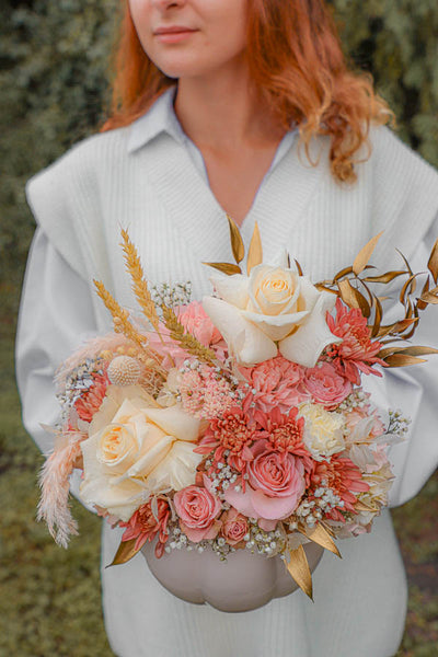 flowers in a pumpkin, fall arrangement; white and pink flowers