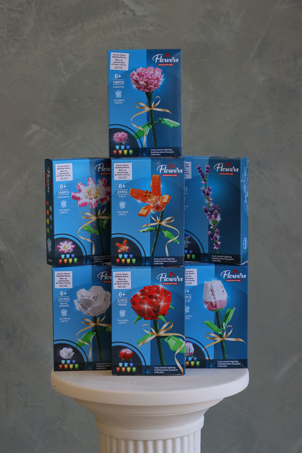 Stacked display of light-up flower building block kits including rose, tulip, lily, carnation, and more – great gift or bouquet add-on