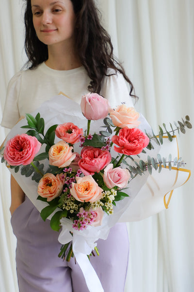 Playful spring bouquet featuring vibrant pink and peach roses, full of joyful, funky vibes perfect for brightening any occasion.