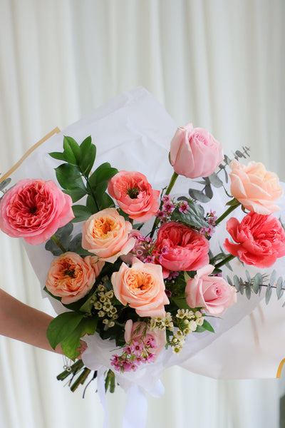 Playful spring bouquet featuring vibrant pink and peach roses, full of joyful, funky vibes perfect for brightening any occasion.