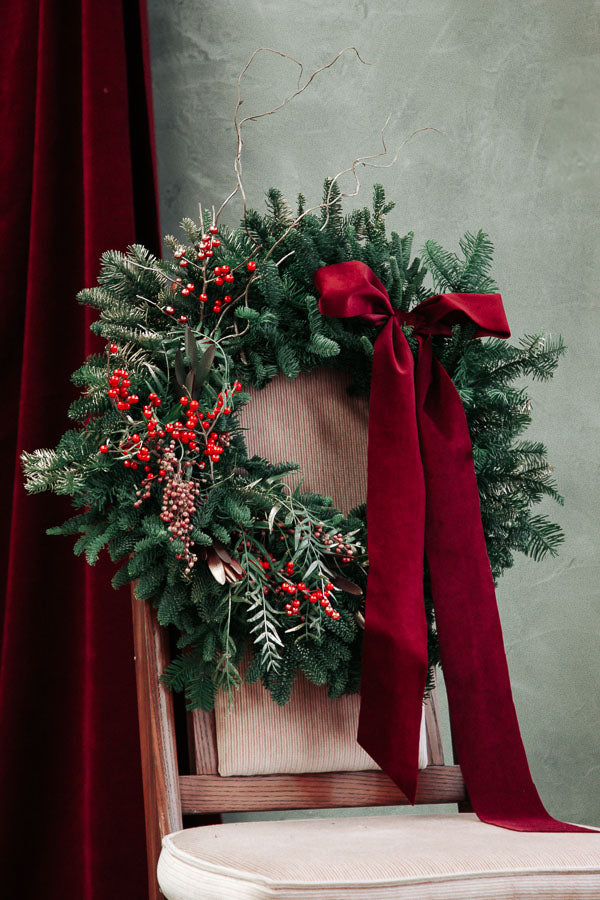 Merry Berry Bow Christmas wreath with red berries, lush greenery, and a red bow by Ottawa florist.
