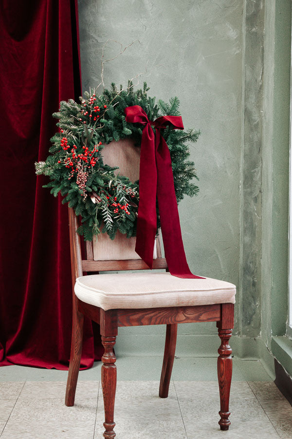 Merry Berry Bow Christmas wreath with red berries, lush greenery, and a red bow by Ottawa florist.