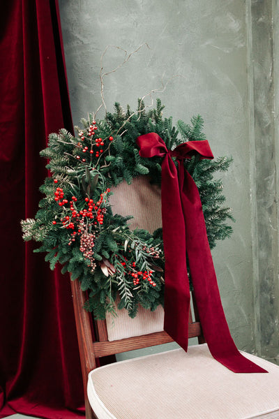 Merry Berry Bow Christmas wreath with red berries, lush greenery, and a red bow by Ottawa florist.