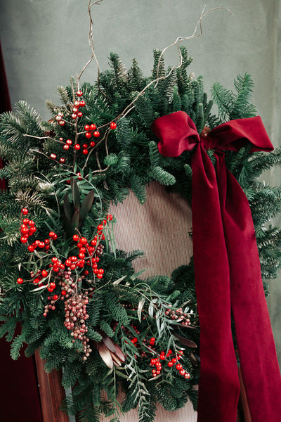 Merry Berry Bow Christmas wreath with red berries, lush greenery, and a red bow by Ottawa florist.