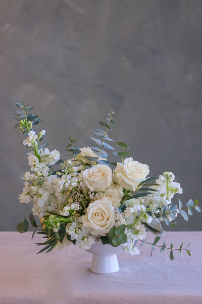 Small wedding and event table centerpiece with white flowers and white roses