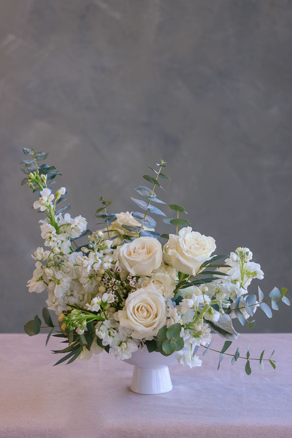 Small wedding and event table centerpiece with white flowers and white roses