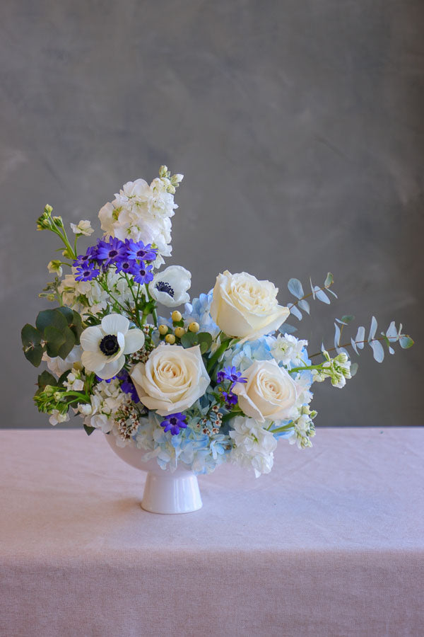 Small wedding and event table centerpiece with white and blue flowers