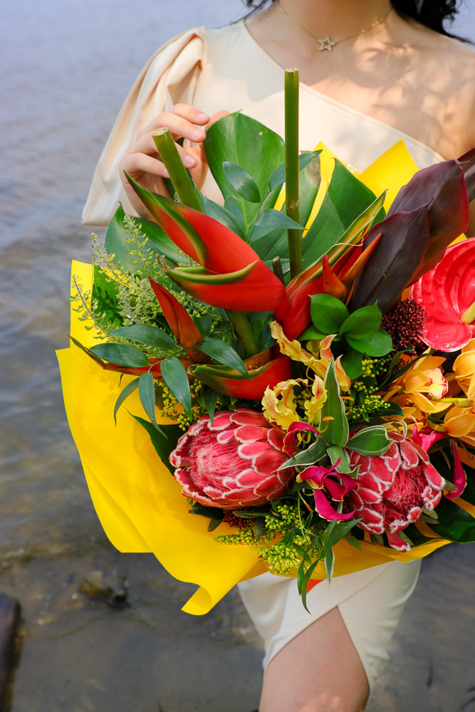 Bouquet with vibrant tropical blooms and exotic foliage by Ottawa florist, proteas, heliconias, orchids, anthuriums, gloriosa