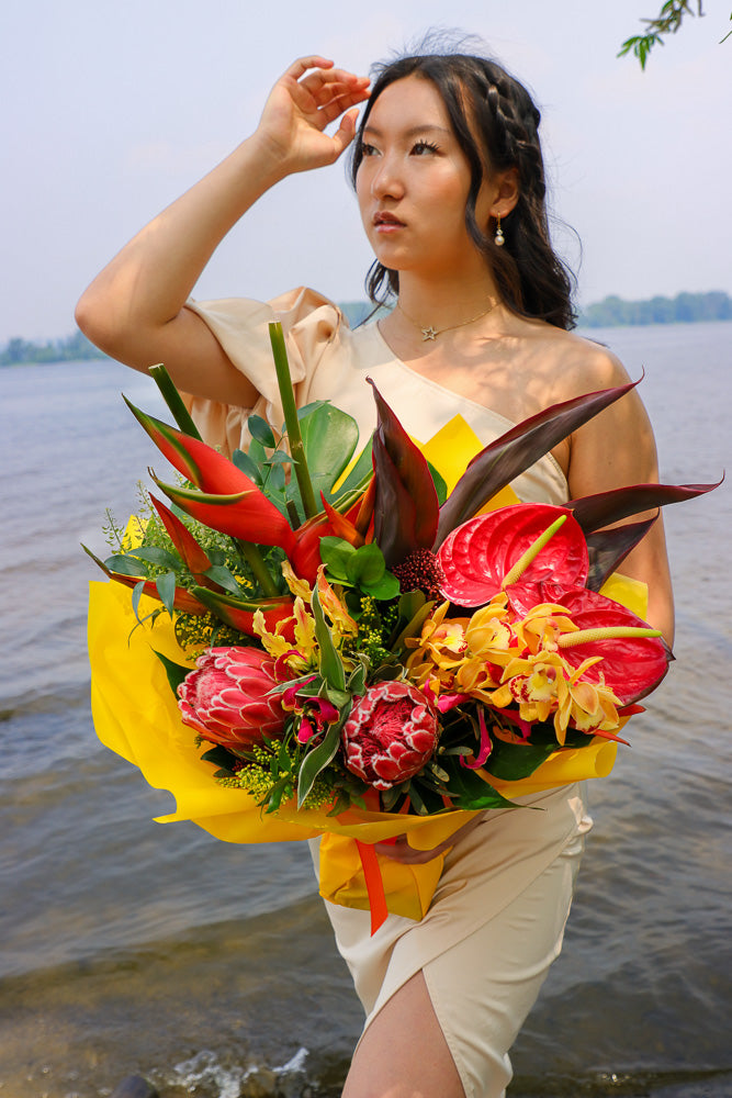 Bouquet with vibrant tropical blooms and exotic foliage by Ottawa florist, proteas, heliconias, orchids, anthuriums, gloriosa