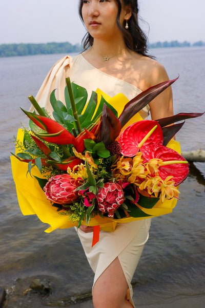 Bouquet with vibrant tropical blooms and exotic foliage by Ottawa florist, proteas, heliconias, orchids, anthuriums, gloriosa