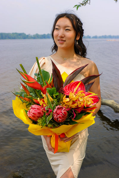 Bouquet with vibrant tropical blooms and exotic foliage by Ottawa florist, proteas, heliconias, orchids, anthuriums, gloriosa