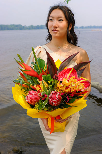 Bouquet with vibrant tropical blooms and exotic foliage by Ottawa florist, proteas, heliconias, orchids, anthuriums, gloriosa