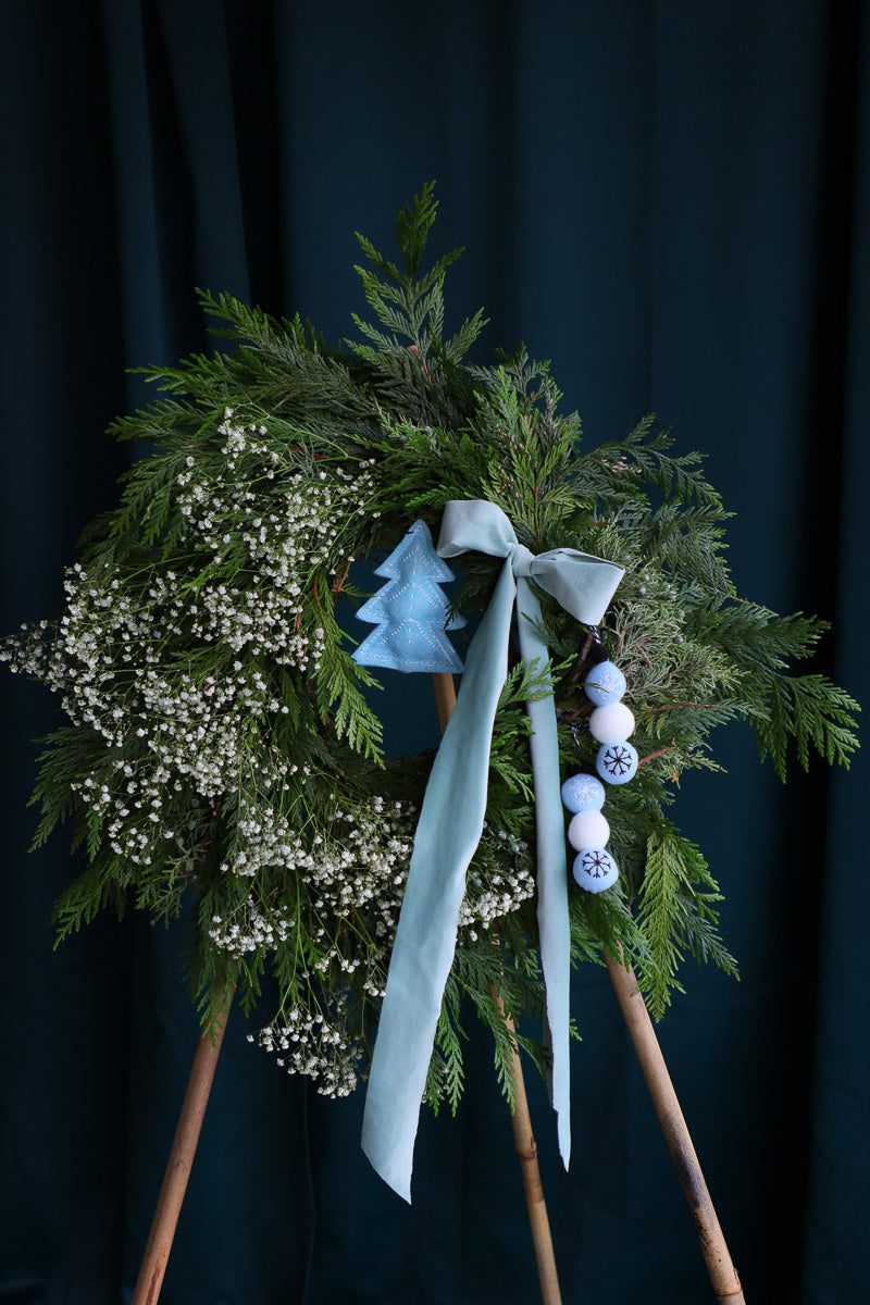 White and blue winter wreath with teal velvet ribbon, fleece ornaments, and baby’s breath – flower delivery Ottawa