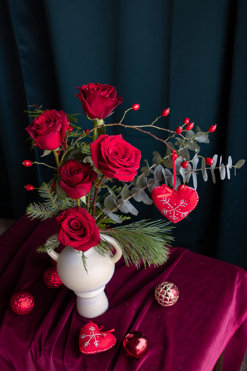 Minimalist red roses arrangement with fleece heart ornament and greenery