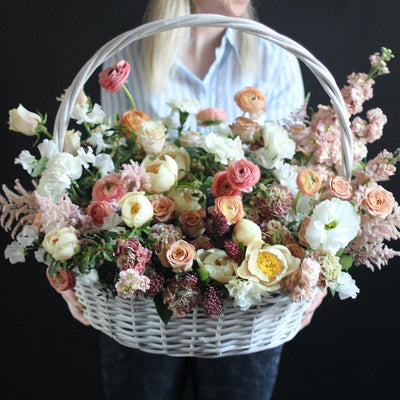 beautiful ranunculuses and roses in a basket