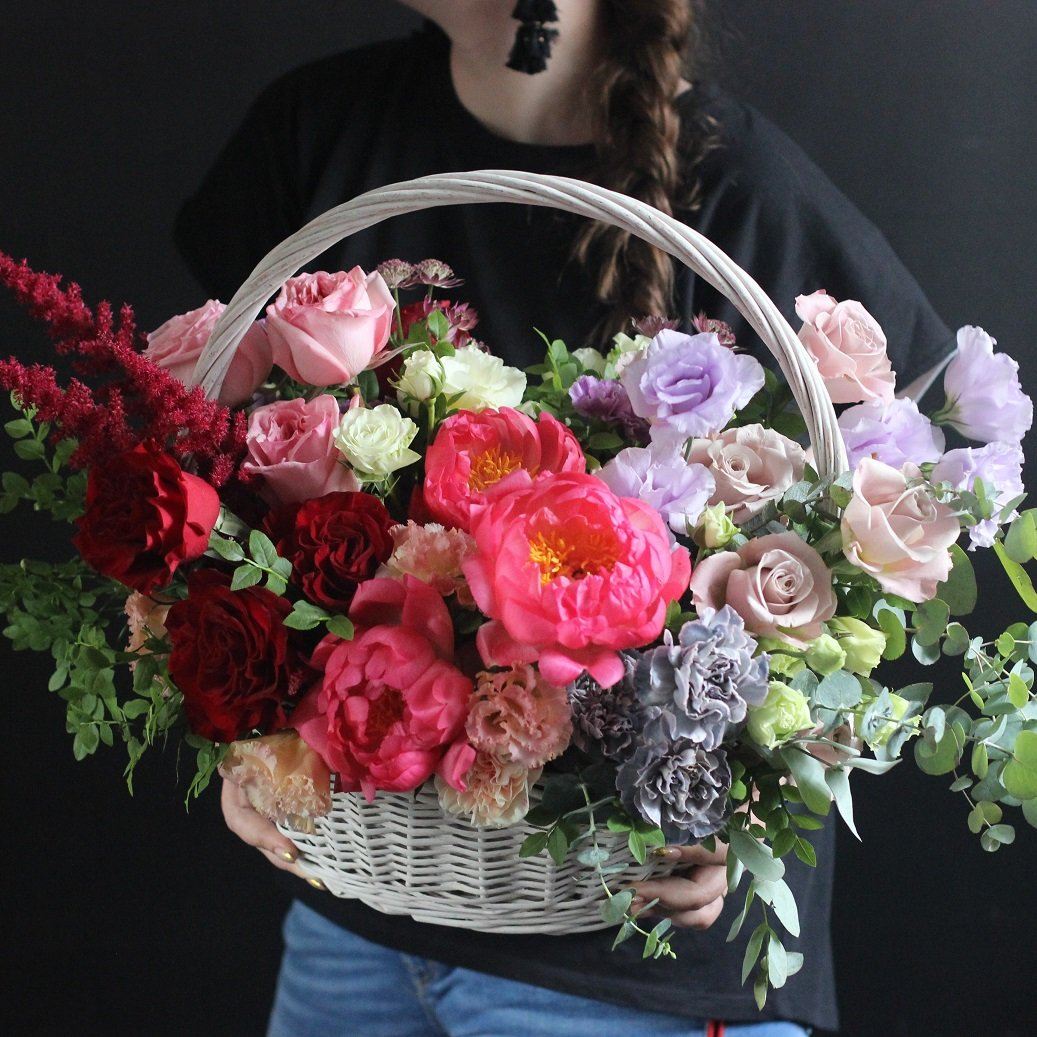 red, pink and lavender flowers in a basket
