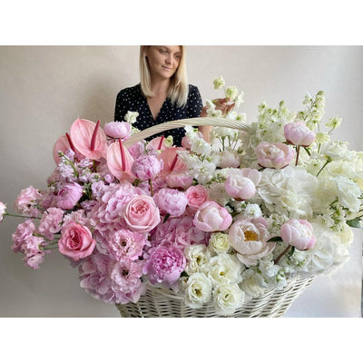 white and pink flowers in a big basket
