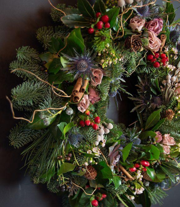Christmas Wreath with flowers, berries and cinnamon