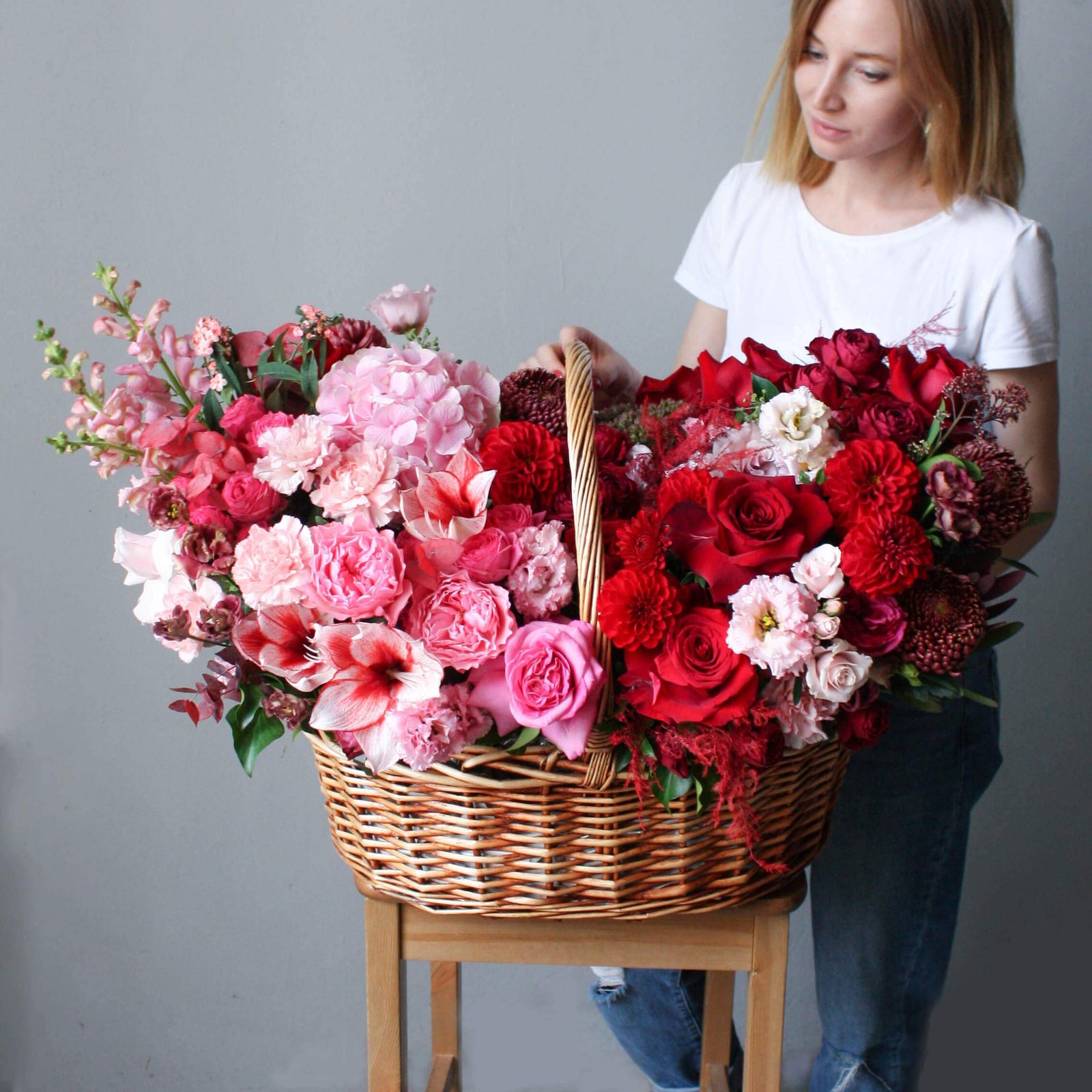  beautiful pink, red and burgundy blooms in a big wooden basket; luxury flower basket