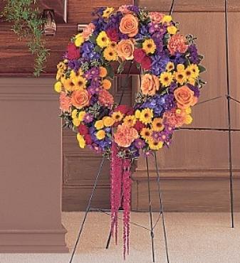 funeral wreath; orange, red, yellow and purple sympathy flowers