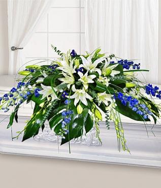 white and blue flowers for funerals; luxury lilies sympathy arrangement
